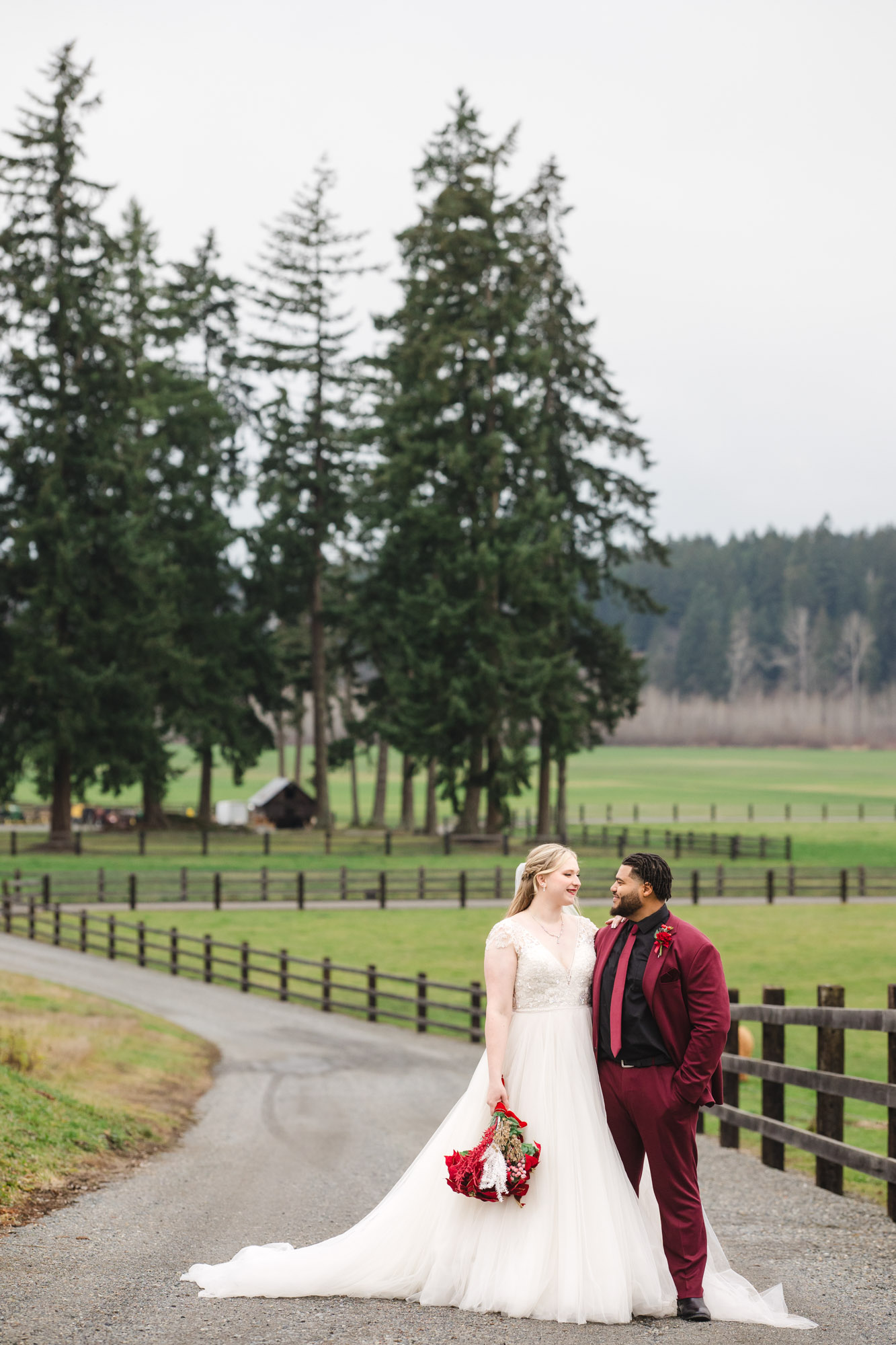 Kelley Farm Wedding couple looking at each other in front of beautiful PNW evergreens.
