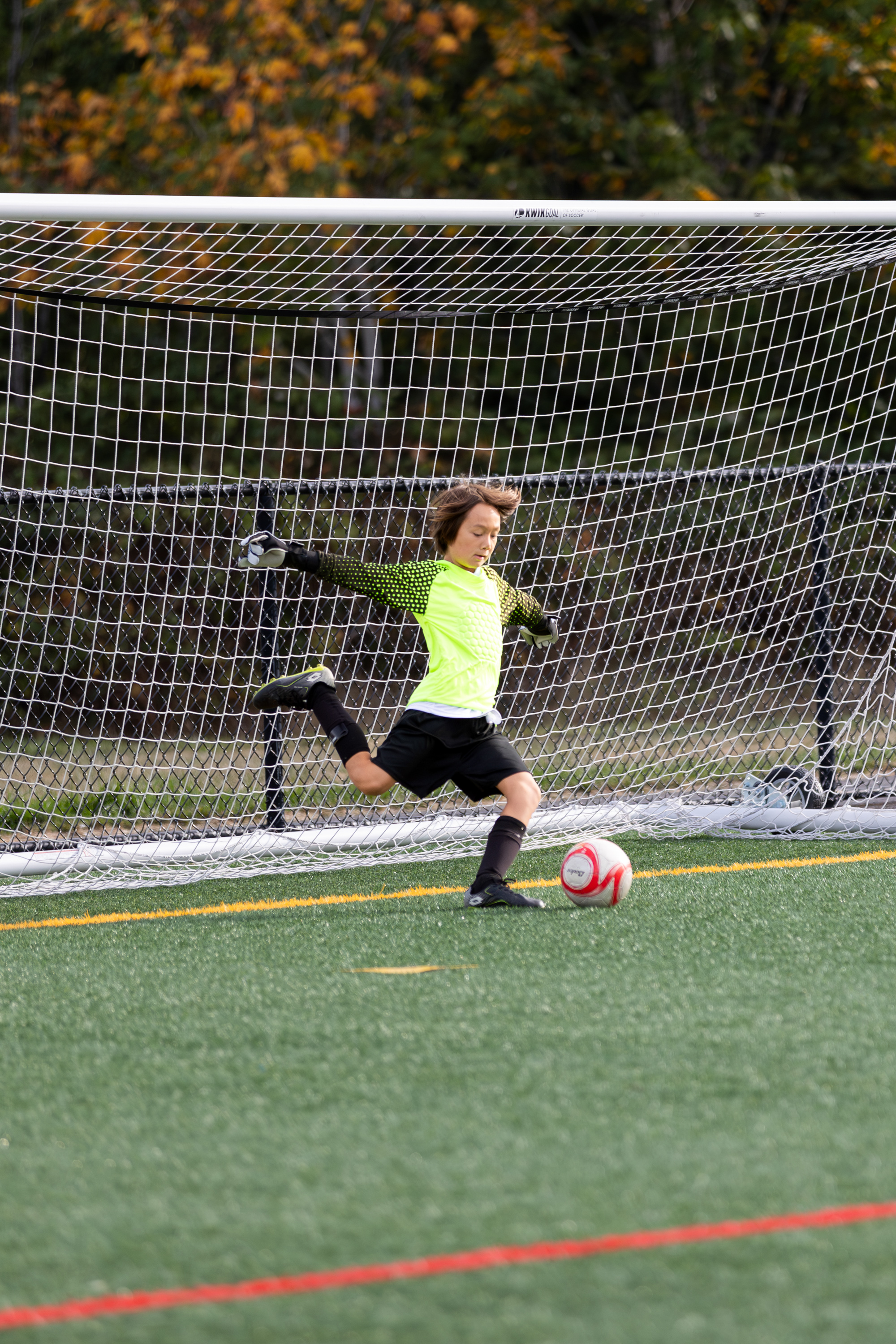 sammamish sports photographer, 1 kid kicking soccer ball from goal